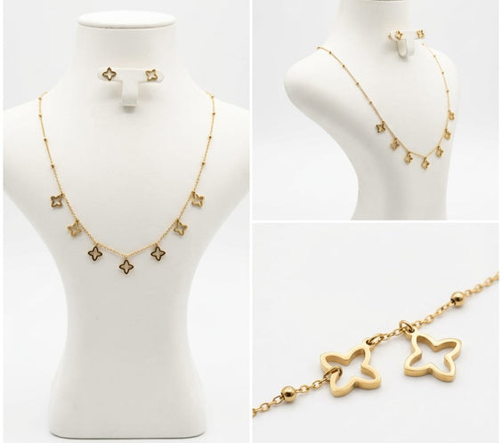Ensemble collier et boucles d'oreilles trèfles dorés.