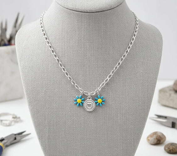 Collier personnalisable en acier inoxydable argent avec charms fleurs bleues et médaille cœur estampée à la main