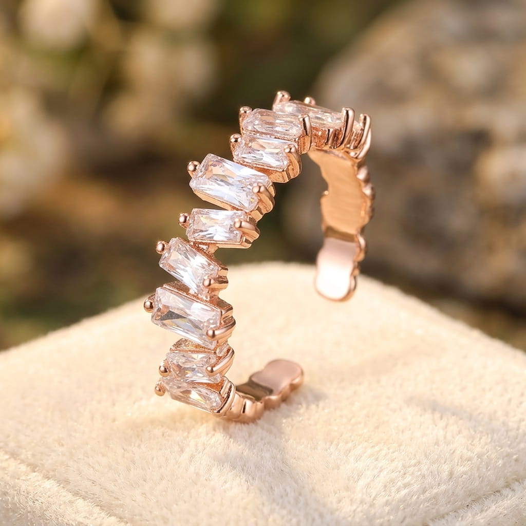 Gros plan d'une bague ajustable en or rose sertie de cristaux de zircon clairs sur un support en velours beige.